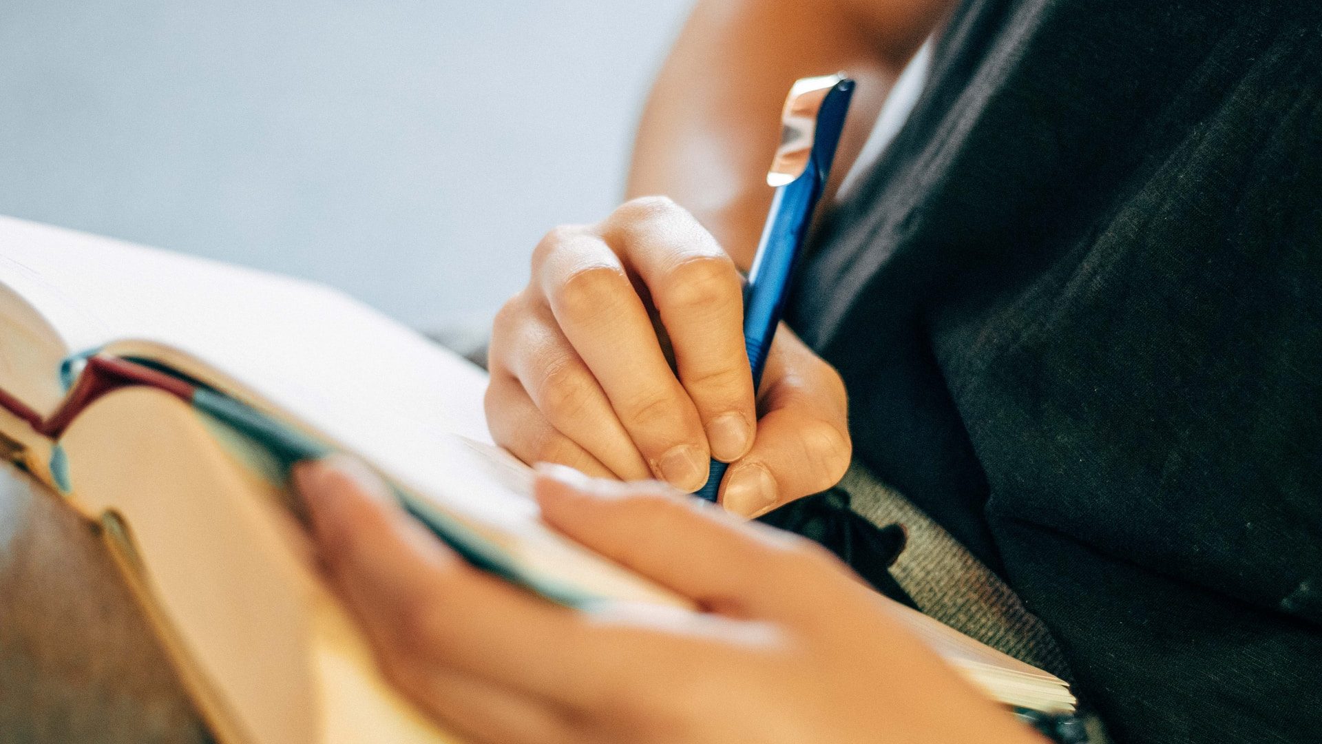 shallow focus photo of person writing